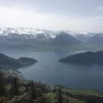 Scenic panoramic view from Mt. Rigi showing Lake Lucerne, surrounding Swiss villages, and snow-capped Alpine peaks