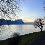 Tranquil lakeside sunset at Brougierpark in Vitznau with Bürgenstock and Mount Pilatus in the background