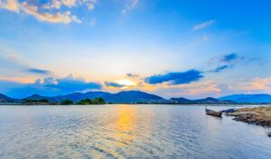 Sunset over a mountain lake with reflections