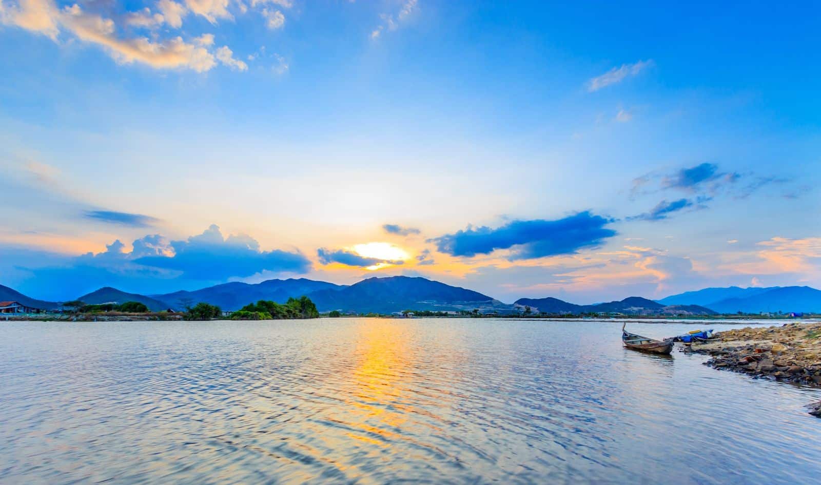Sunset over a mountain lake with reflections