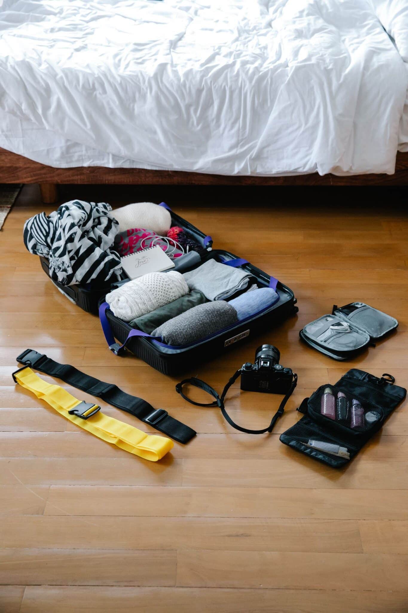 Open suitcase packed with travel essentials