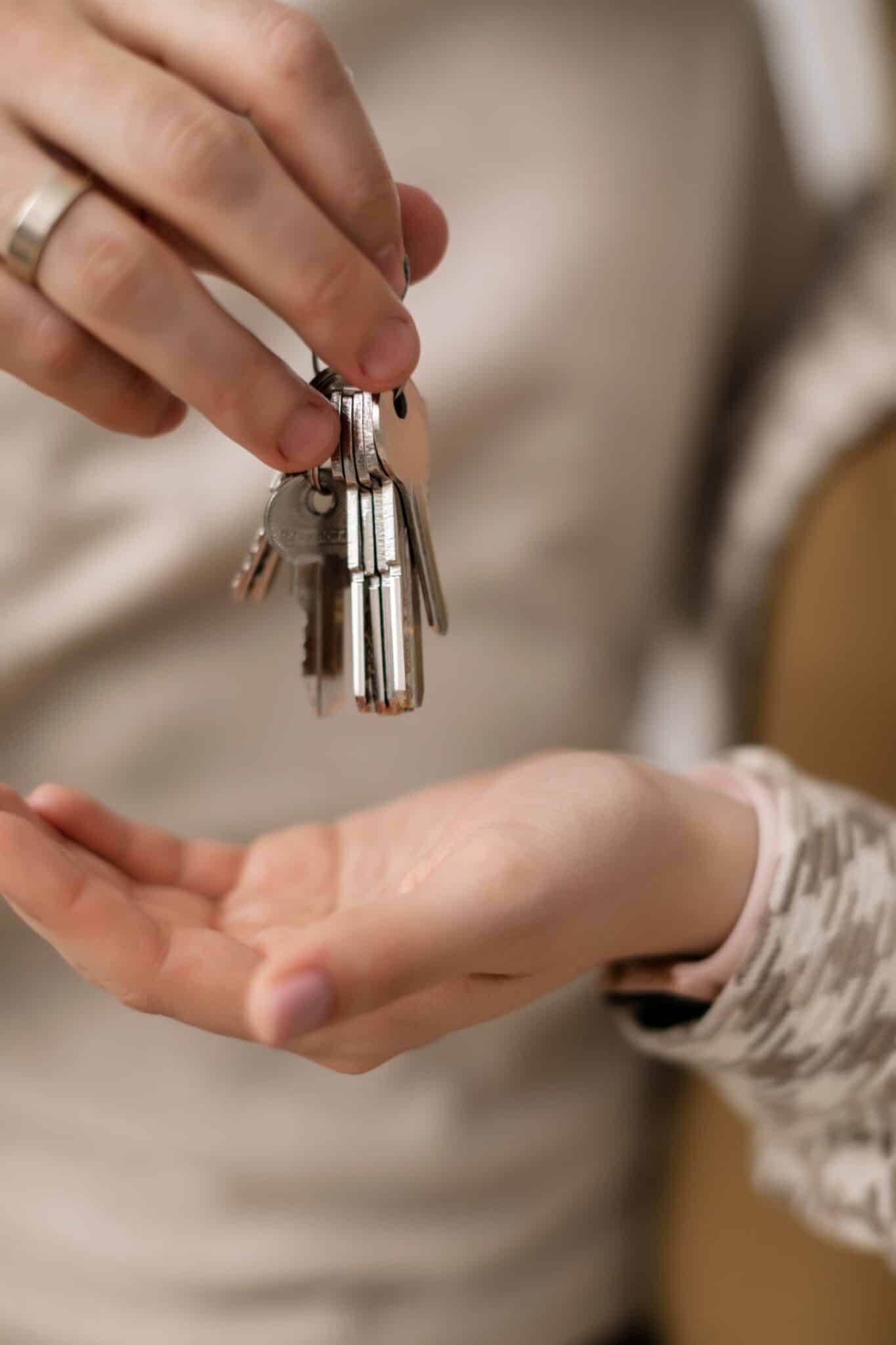 Hands exchanging house keys